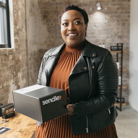 happy-small-business-black-woman-holding-a-sendle-parcel-ready-for-shipping-delivery