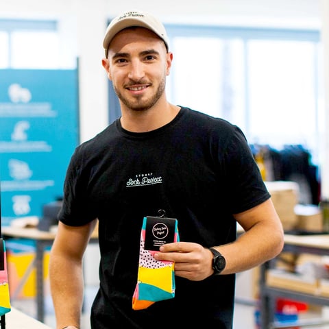 Andres holding a Sydney Sock Project colored socks