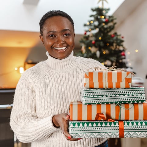 woman-holding-gift-boxes-for-shipping-no-peak-surcharges-1080x1080