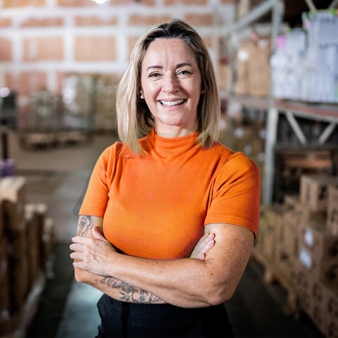 a-woman-inside-a-big-warehouse-smiling