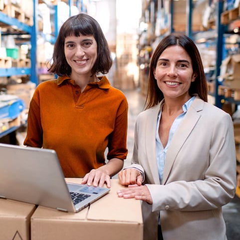 two-woman-in-a-warehouse-with-a-laptop