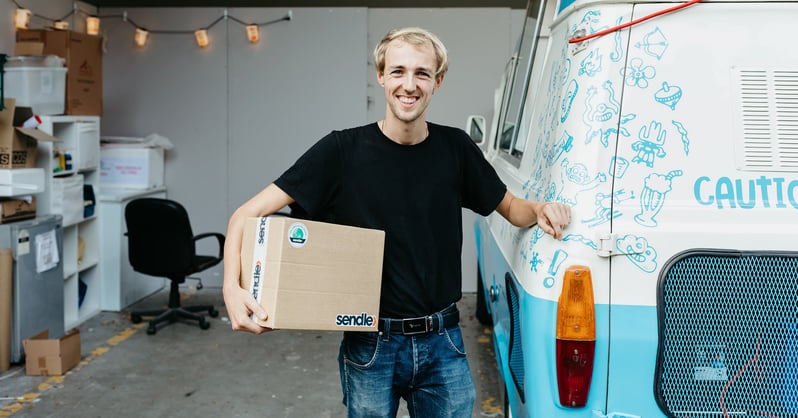 a-sendle-customer-guy-holding-a-big-package-ready-for-shipping