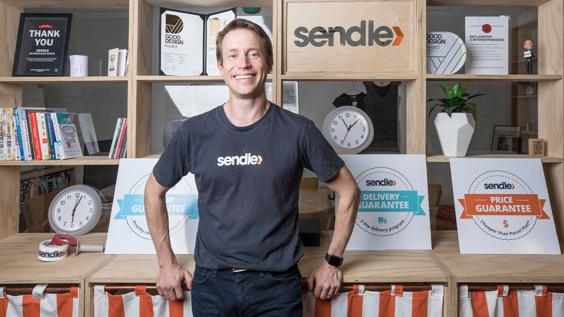 Sendle CEO Founder James Chin Moody standing behind the books shelf