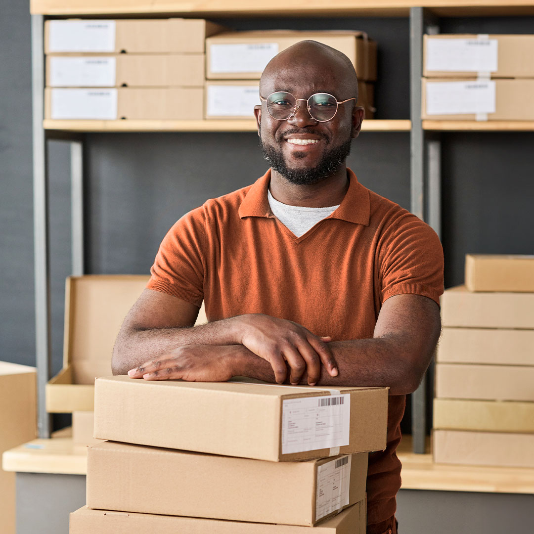 A smiling man with a lot of packages