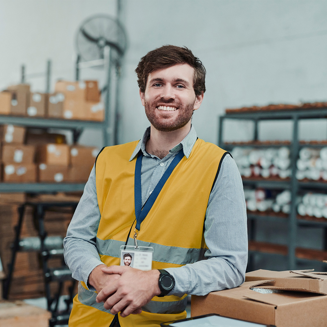 business-owner-guy-smiling-with-a-background-of-boxes