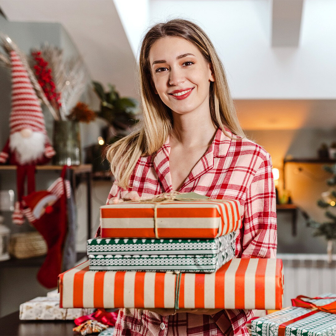 happy-woman-carrying-gifts-on-christmas