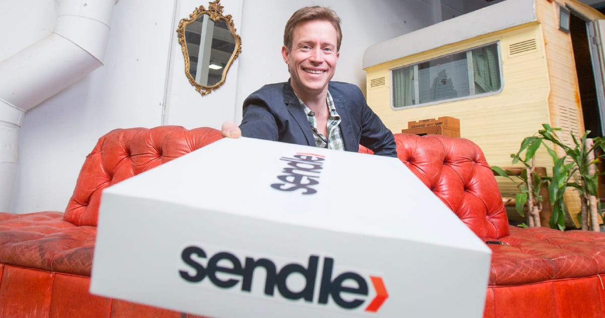 Sendle CEO Founder James Chin Moody holding a white Sendle parcel