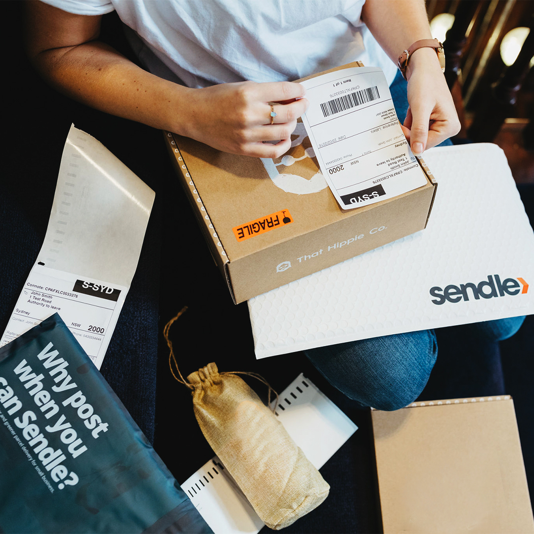 sendle-business-owner-hands-packing-wrapping-parcels-ready-for-shipping