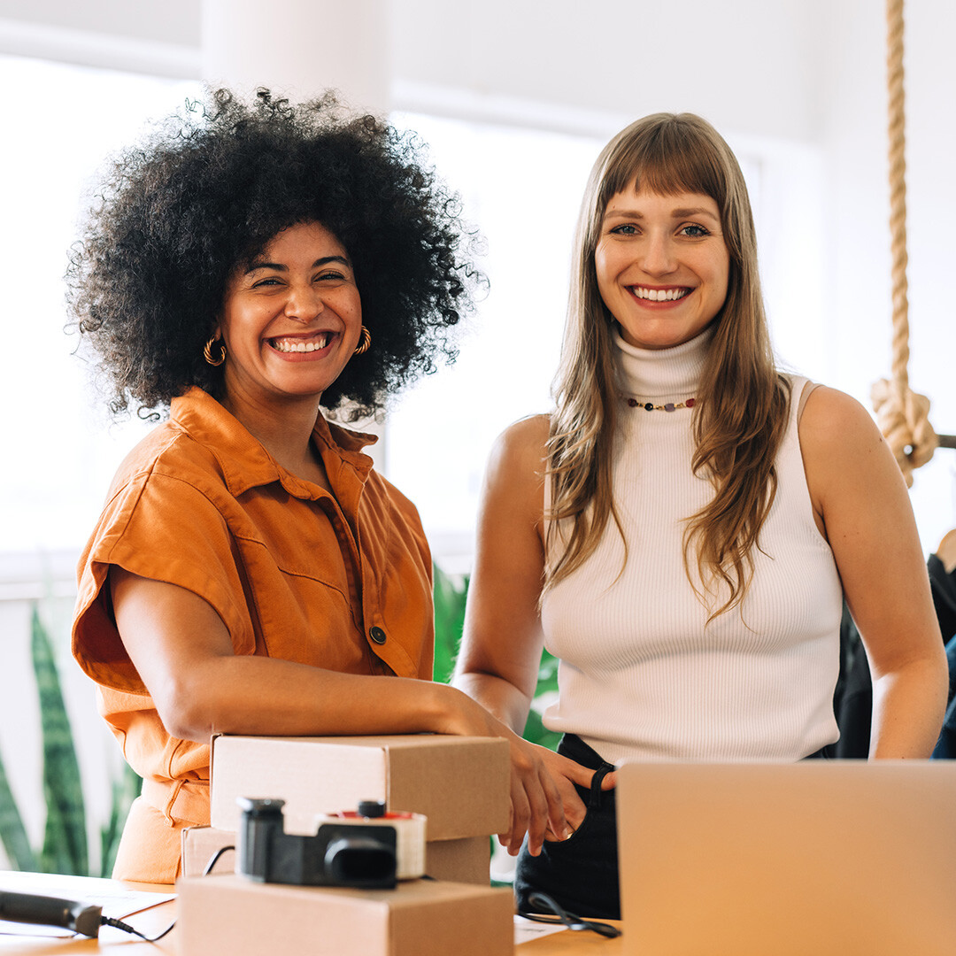 two-happy-woman-entrepreneur-selling-clothes