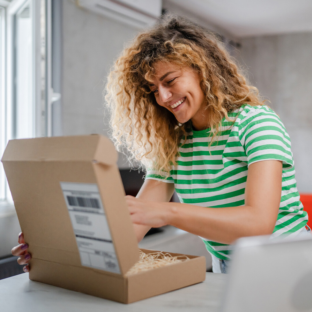 person-packing-a-parcel-smiling